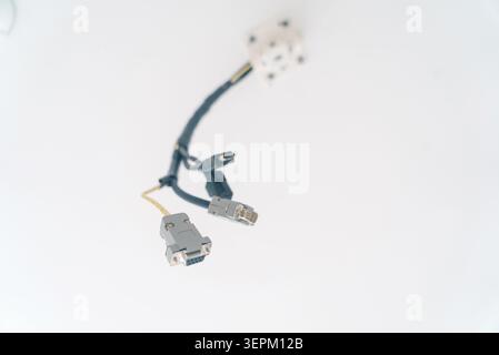A close-up image of a network cable with two connectors on a white background, illustrating electronic data transfer, wiring, and computer hardware co Stock Photo