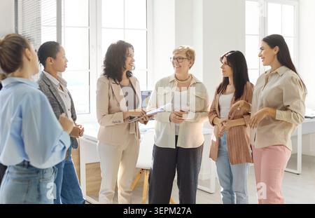 Female professionals in office discussing strategy, mentoring teamwork and planning Stock Photo