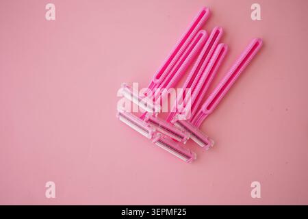 Women use pink razors for shaving in the bathroom Stock Photo