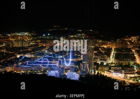 Bilbao at night Urban landscape panorama at night featuring an illuminated outline of a futuristic car and a prominent modern skyscraper standing tall Stock Photo