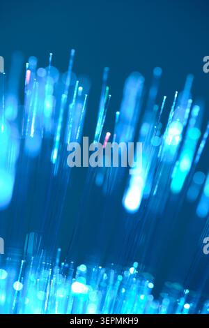 Vertical blue fiber optic lines macro shot with beautiful glowing bokeh dots Stock Photo