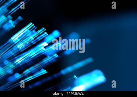 Brilliant cyan and light blue glowing fiber optic tips creating bright technological explosion Stock Photo
