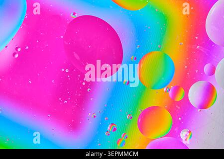 Abstract macro shot colorful oil bubbles floating in fluid, creating vibrant pattern Stock Photo