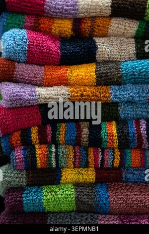 Macro shot highlighting the fluffy terry cloth texture and vivid color bands of stacked bathroom or beach towels Stock Photo