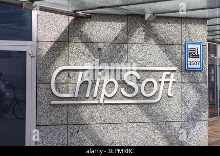 Amsterdam, Netherlands, 31 May 2026. Architectural close up of the white ChipSoft company name logo mounted on a granite tile wall next to a blue West Stock Photo