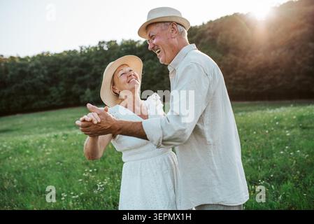 Elderly man and woman spending time in nature. Stock Photo