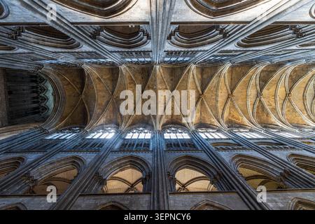 Extraordinary low angle view looking up at the majestic stone ribbed vaults inside Rouen Cathedral, Normandy. The symmetrical shot highlights the goth Stock Photo