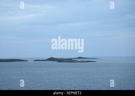 Small rocky islands in the Stockholm archipelago near Nynäshamn, surrounded by calm Baltic Sea waters. Stock Photo