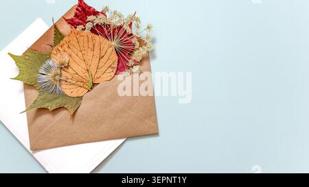 Autumn Greeting Card Mockup with Envelope, Dried Leaves, and Copy Space, for Seasonal Greetings, Thanksgiving Designs, Fall Marketing, Handmade Crafts Stock Photo