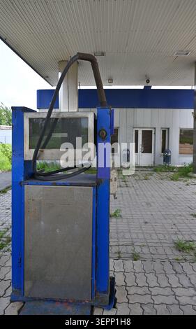Close-up of a rusty, broken fuel dispenser at an abandoned gas station Stock Photo