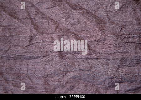 Wrinkled brown fabric texture background with creased textile detail and rustic folds Stock Photo