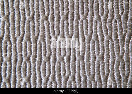 Beige quilted fabric texture with repeating organic pattern for interior design and soft home decor Stock Photo