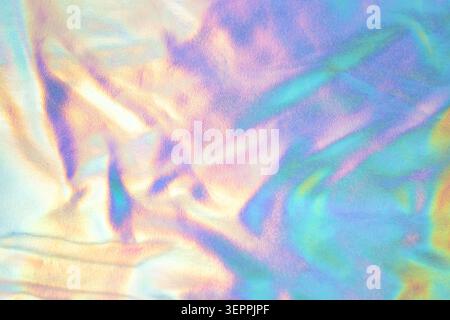 Iridescent holographic pastel fabric texture background with soft rainbow light and abstract shimmer Stock Photo