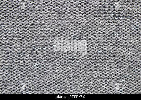 Gray knitted fabric texture close-up with repeating stitch pattern and soft woolen look Stock Photo