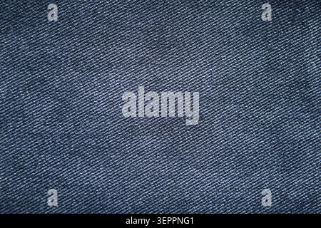 Blue denim fabric texture close-up showing diagonal twill weave and detailed cotton thread pattern for backgrounds Stock Photo