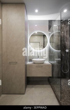 Minimalist contemporary bathroom interior with glass shower Stock Photo