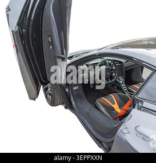 High-performance luxury car interior featuring black and orange upholstery highlighting sleek design elements and modern controls enhancing comfort an Stock Photo