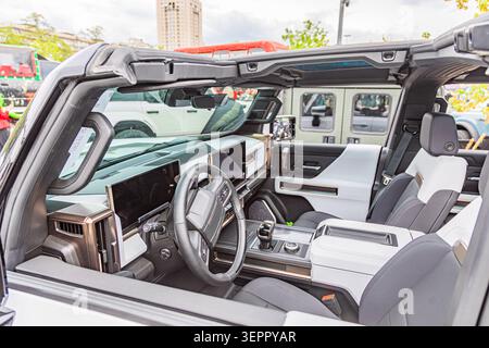 Luxury SUV interior featuring sleek design and advanced features including leather upholstery, metallic accents, large touchscreen display, gear shift Stock Photo