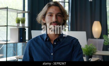 Arabian eastern business man looking at camera calm ethnic businessman Indian guy male Hispanic manager company ceo working developing project look Stock Photo