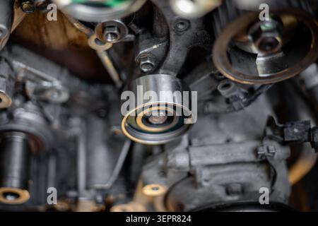 View of drive belts and tensioners in an engine bay during maintenance. belt routing, engine service, auto repair Stock Photo