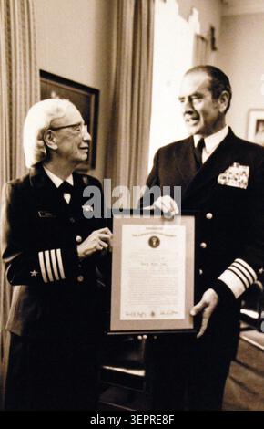 Chief of Naval Operations, presents a certification of promotion to the rank of Captain to Commander Grace Hopper, Stock Photo
