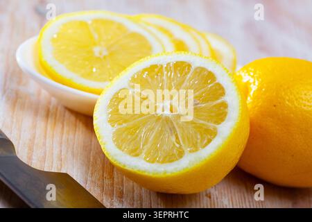 Sliced lemon on wooden table Stock Photo