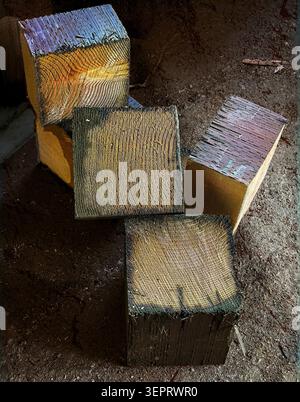 Blocks of wooden cubes scattered on roiugh dirt background. Geometric shapes. Stock Photo