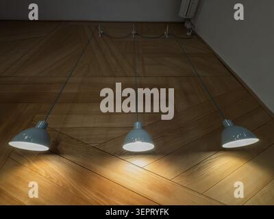 Three light blue pendant lamps hang low and illuminated over a light wooden floor with a geometric parquet pattern, showing indoor lighting, warm shad Stock Photo