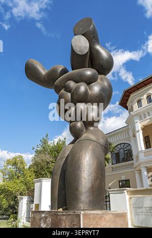 An abstract bronze sculpture stands as a memorial to the victims of communism in front of the political persecution office building, Tirana, Albania Stock Photo