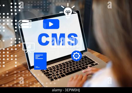 Using a content management system on a laptop for website management and design tasks Stock Photo