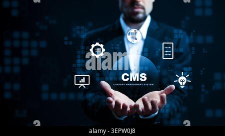 Man presenting content management system icons on digital interface in dark setting Stock Photo