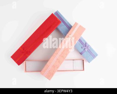 empty rectangular watch bracelet cardboard jewelry boxes with ribbon boows  isolated on a white background flat lay Stock Photo