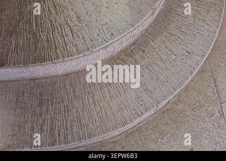 Curved concrete stairs featuring a prominent broom-finish or raked slip-resistant texture, Estonia, Europe. Stock Photo