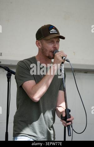 Male singer in a band at Leamington Peace Festival, Warwickshire, UK Stock Photo