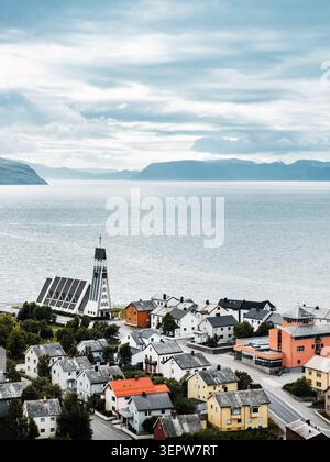 Aerial view of traditional wooden houses nestled on a lush green ...