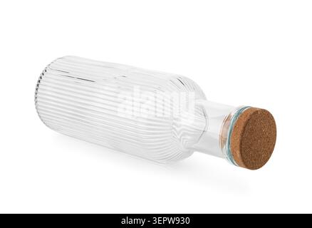 Empty clear glass bottle with cork stopper lying horizontally on white background, ribbed texture design, the bottle features a distinctive ribbed tex Stock Photo
