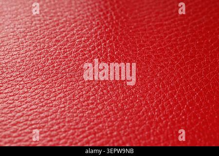 Vibrant red leather texture background with detailed grain pattern, close-up macro view of material surface for design and upholstery Stock Photo