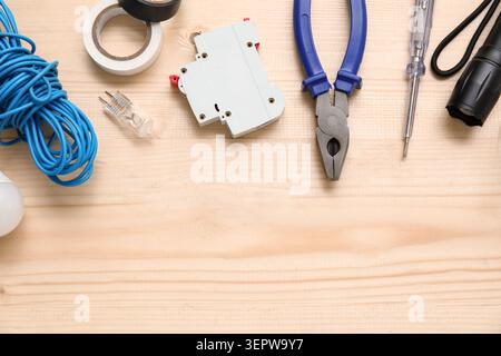 Electricians tools and electronics on wooden background Stock Photo