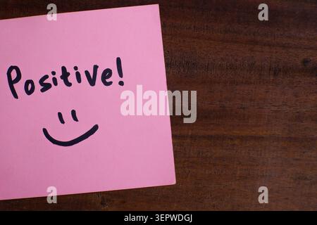 Positive Message Sticky Note on Wooden Background Stock Photo