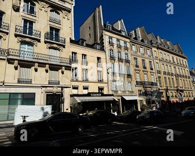 Paris, France - May 14, 2026: Sunlit Parisian street featuring historic Tournon facades, sidewalk cafes, balconies and urban city life. Stock Photo
