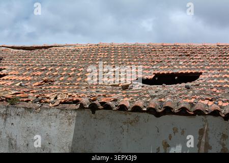 Abandoned residential property in need of urgent construction repairs and home renovation concepts focusing on real estate neglect and decay. Stock Photo