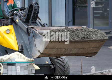 Workers prepare for a busy day as a vehicle transports fresh concrete mix. Kyiv, Ukraine, June 16, 2026 Stock Photo