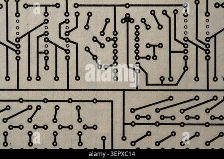 Vintage circuit board diagram layout on textured paper. Close up of a black and white electronic circuit board schematic pattern printed on paper, mac Stock Photo