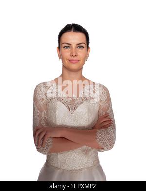 A smiling bride poses in an elegant lace wedding dress with her arms crossed. Stock Photo