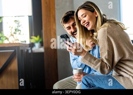 Online entertainment and social media. Diverse, multiethnic couple enjoying the digital world Stock Photo