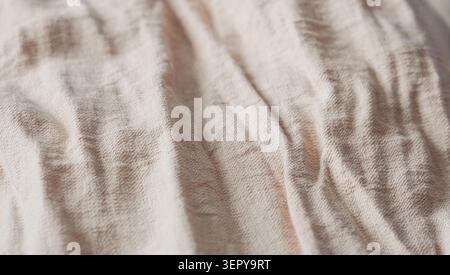 Beige crumpled cotton fabric texture close up. Stock Photo