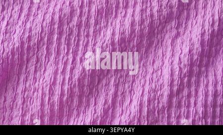 Purple seersucker crumpled fabric texture close up. Stock Photo