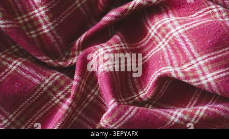 Red and white crumpled plaid fabric texture close up. Stock Photo