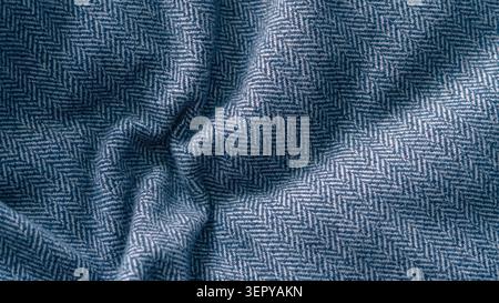 Blue crumpled herringbone fabric texture close up. Stock Photo