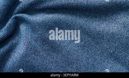 Blue crumpled herringbone fabric texture close up. Stock Photo